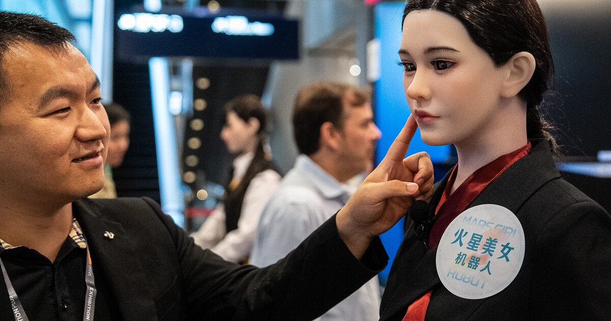 Humanoid robot engaging with visitors at a professional trade show or convention