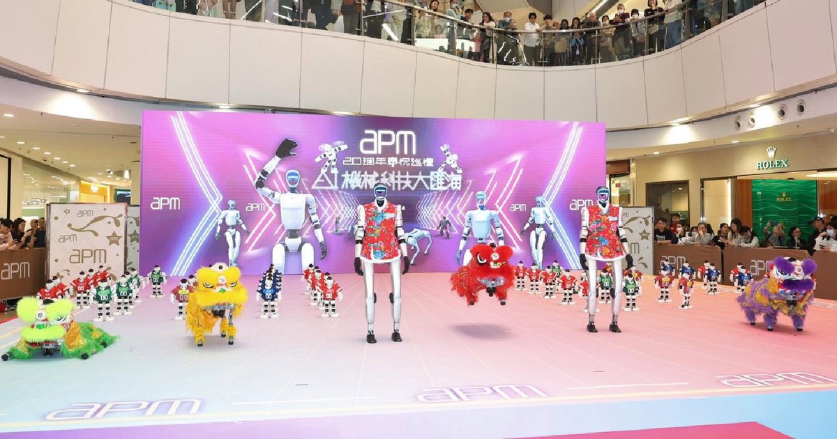 Humanoid robot performing in a busy Kuala Lumpur shopping mall atrium